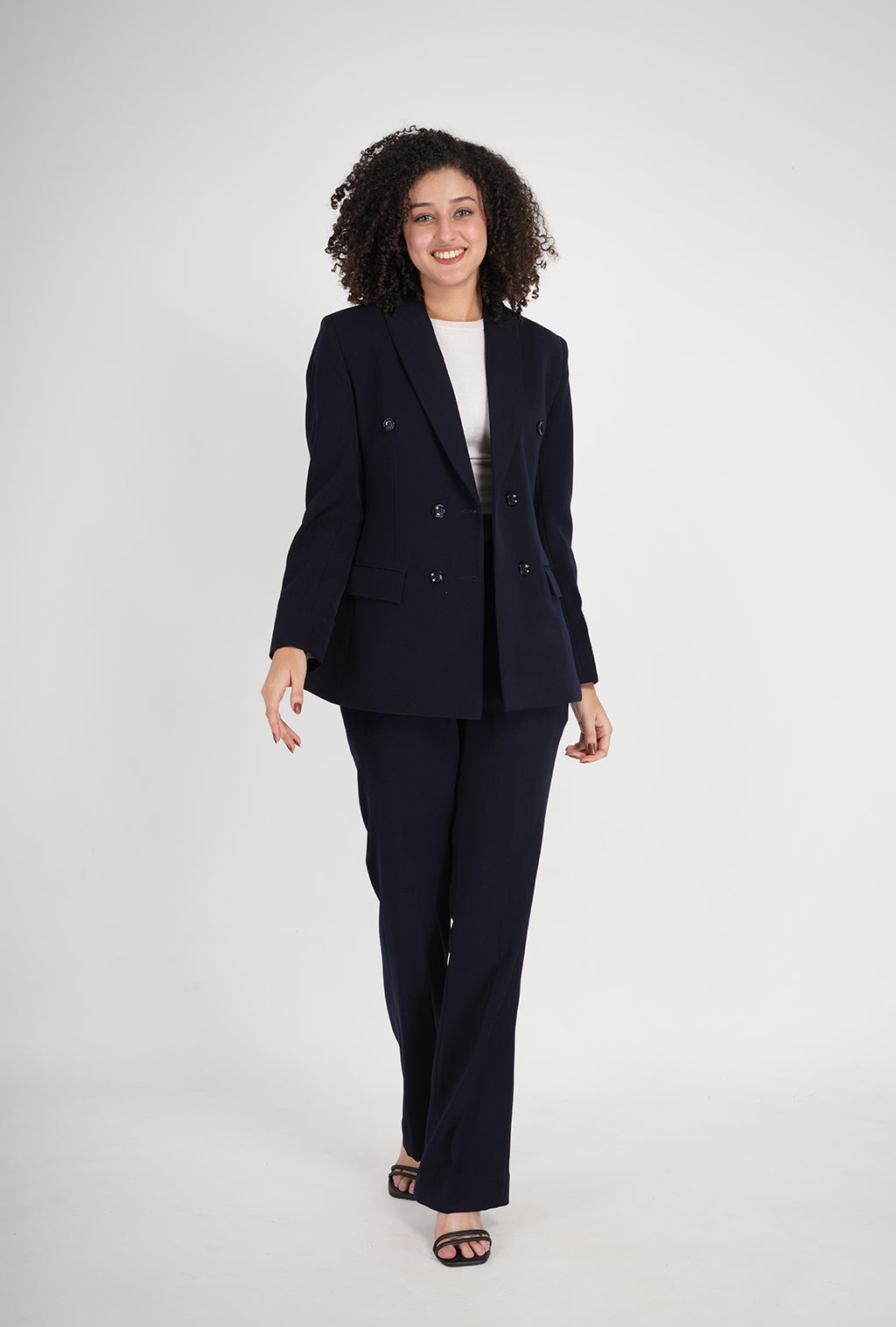 Woman wearing a navy blue suit on a white background