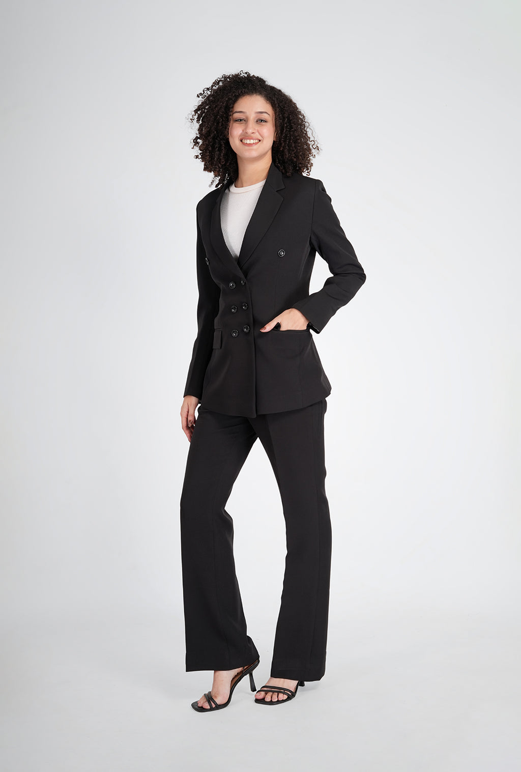 Woman wearing a black suit on a white background