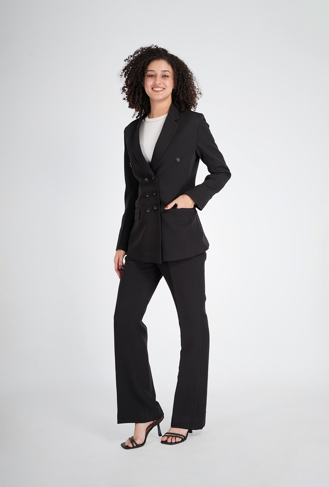 Woman wearing a black suit on a white background