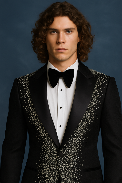 Man wearing a black tuxedo with a bow tie against a blue background