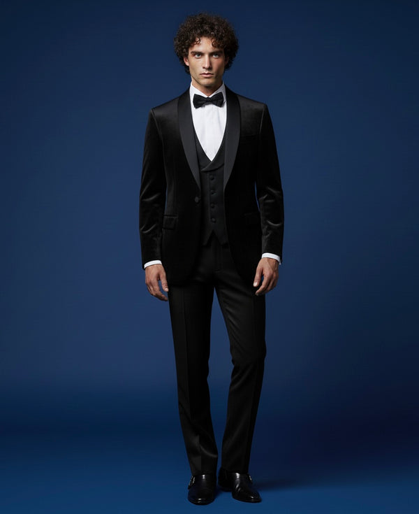 Man wearing a black tuxedo against a blue background