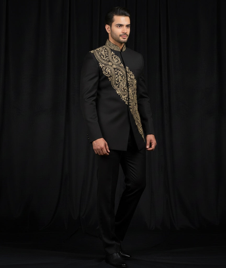 Man wearing a black suit with gold embroidery against a black background