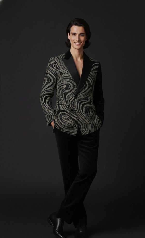 Man wearing a patterned blazer and black pants on a dark background
