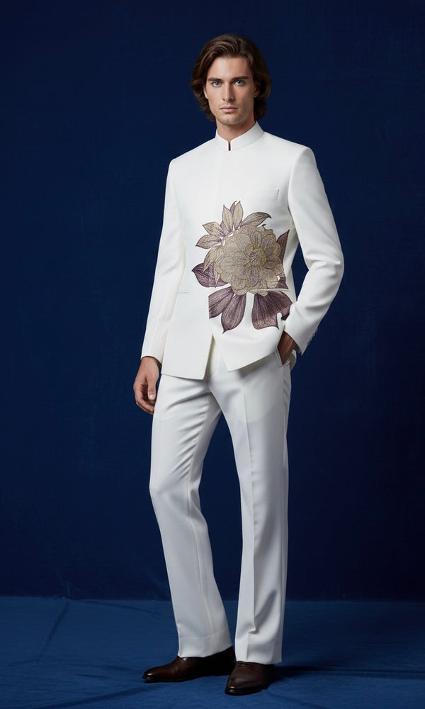 Man wearing a white suit with floral details on a blue background