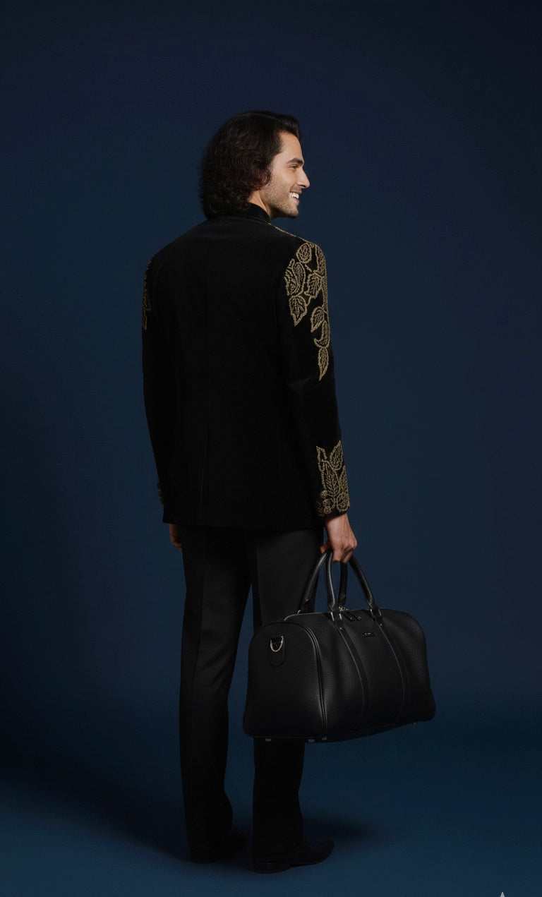Man wearing a black outfit with gold embroidery