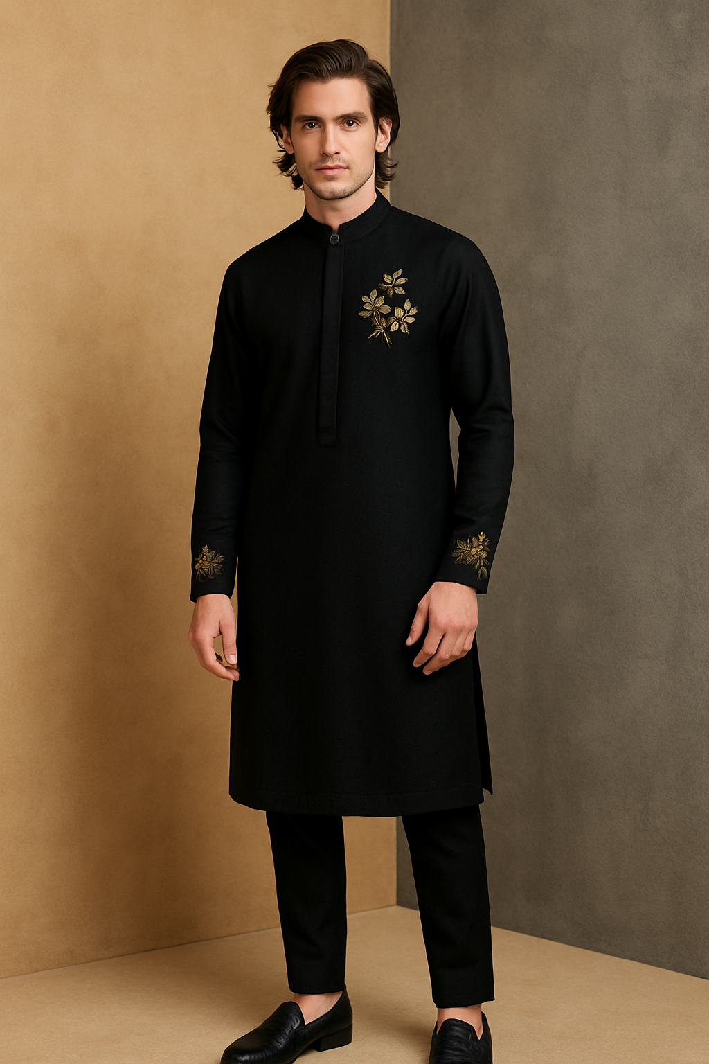Man wearing a black kurta with gold embroidery against a beige and gray background