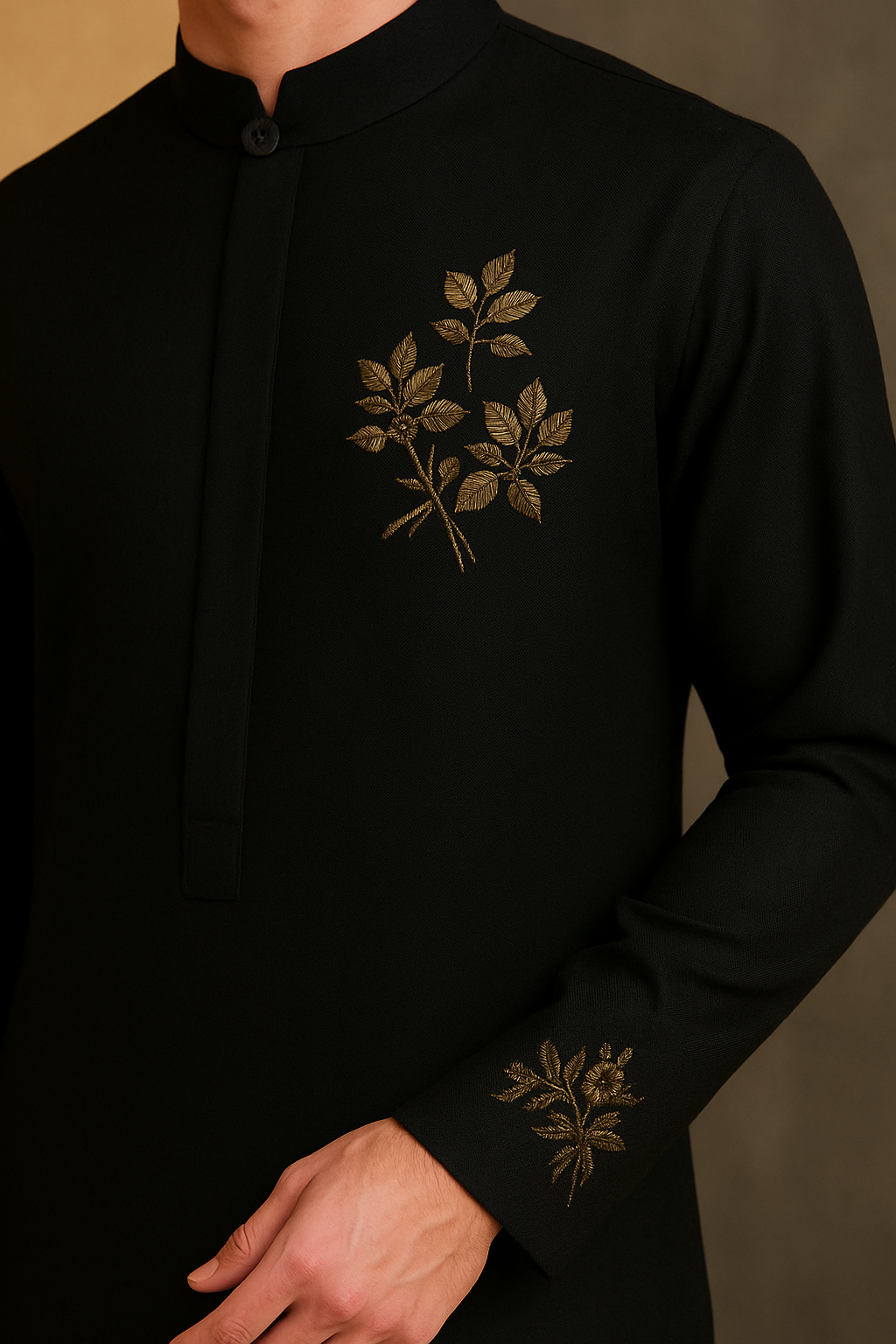 Black shirt with gold leaf embroidery on a neutral background