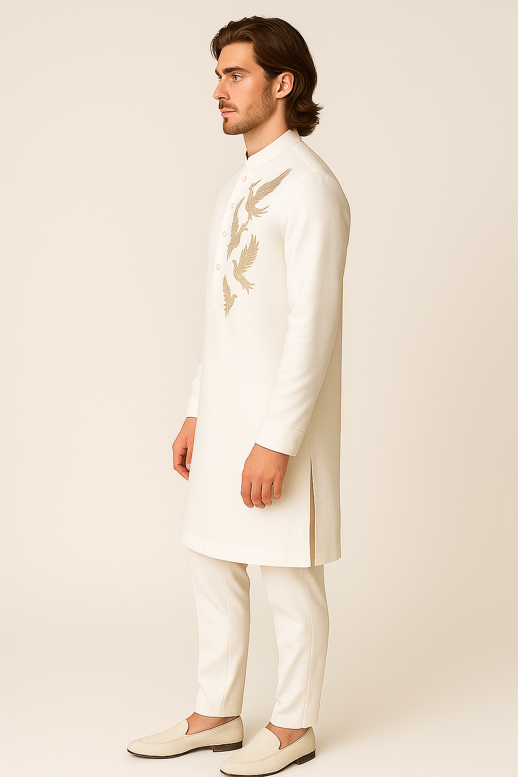 Man wearing a white embroidered traditional outfit on a beige background