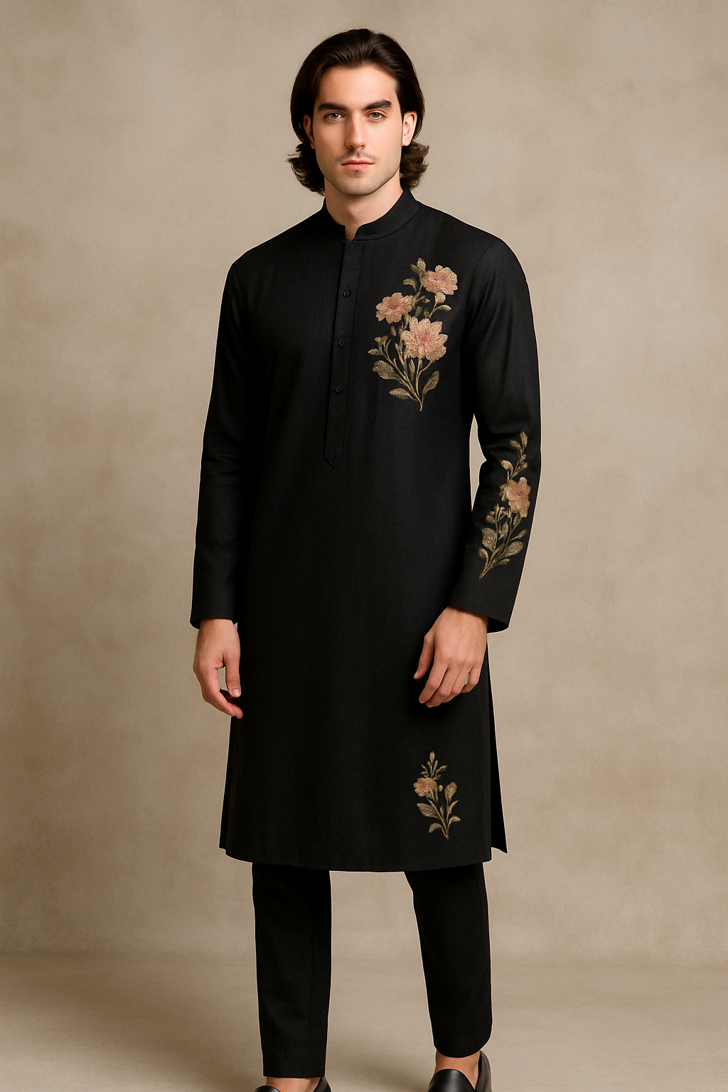 Man wearing a black kurta with floral embroidery against a beige background