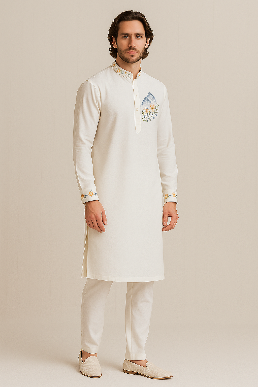 Man wearing a white kurta with embroidery on a beige background
