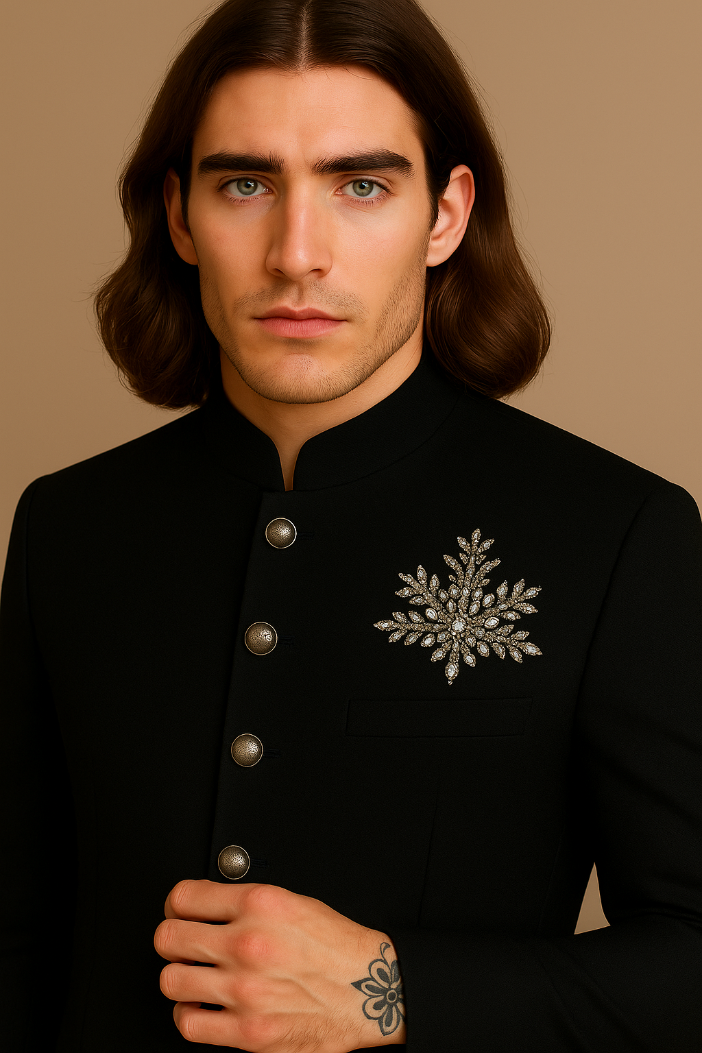Man wearing a black traditional outfit with a decorative brooch on a beige background