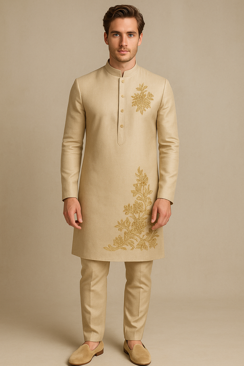 Man wearing a beige embroidered kurta with gold patterns on a beige background
