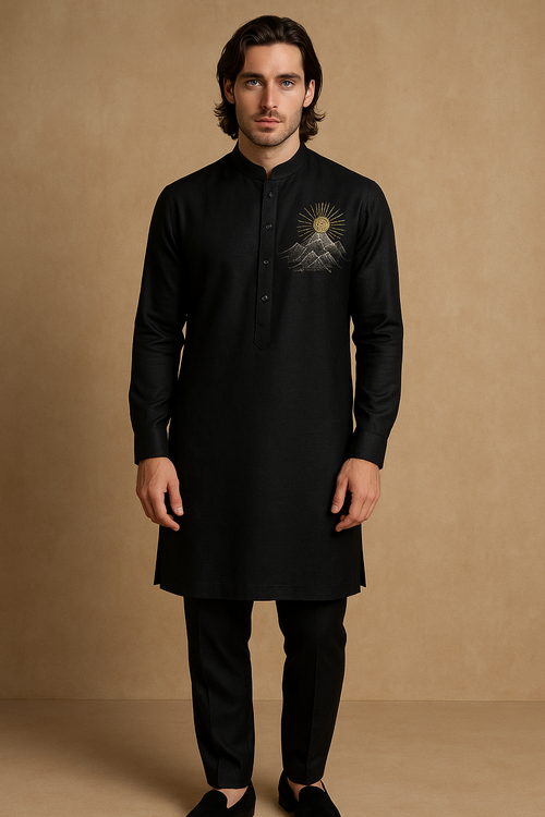 Man wearing a black kurta with embroidery on a beige background